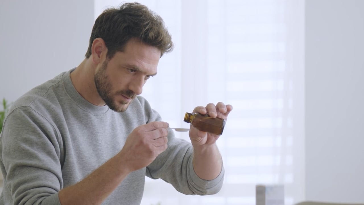 Picture of man taking medicine